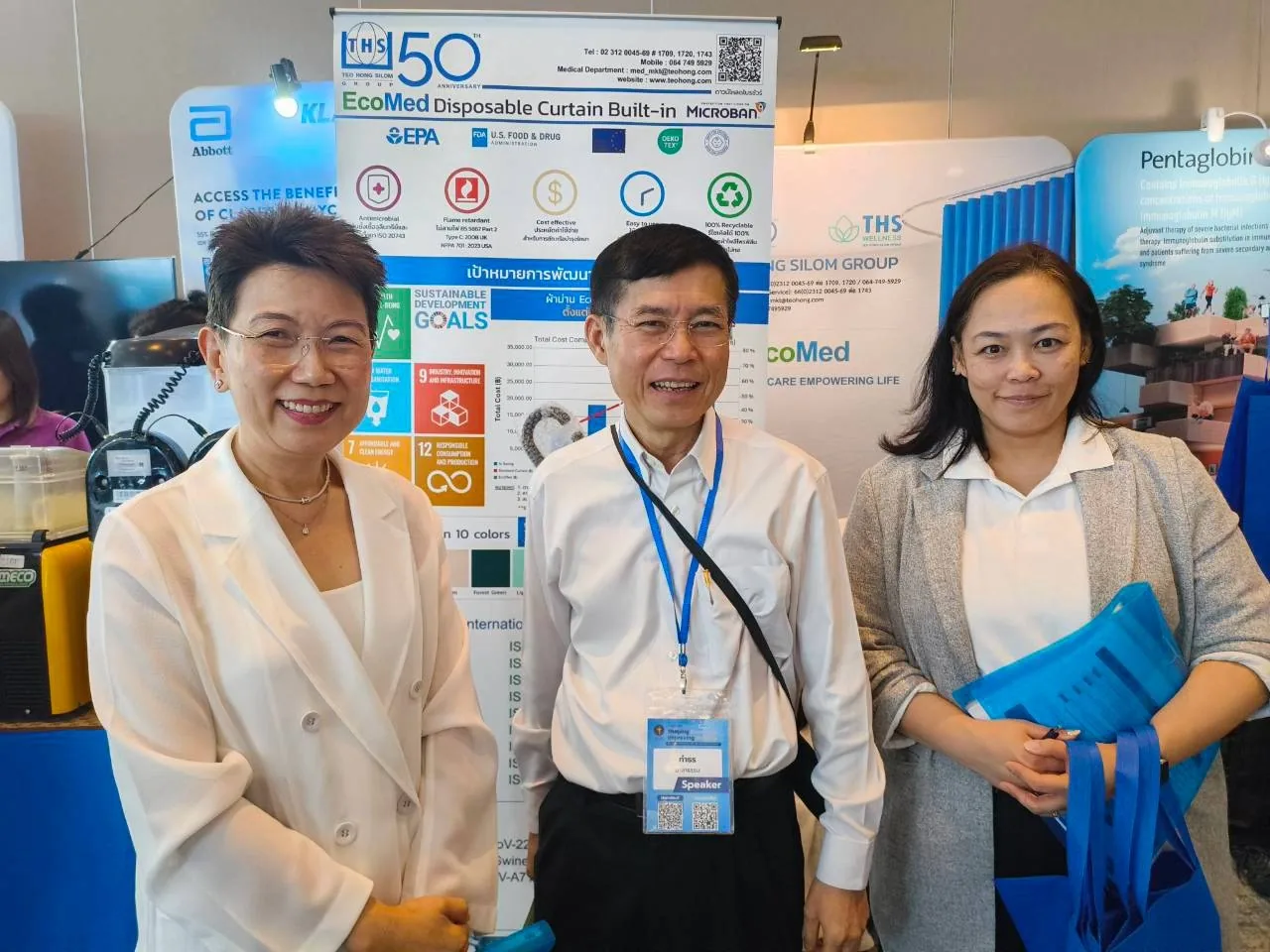 Team members and attendees at the EcoMed booth