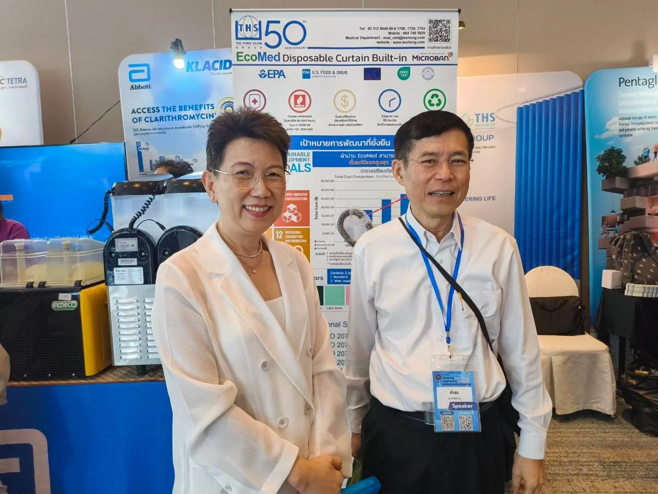 Team members and attendees at the EcoMed booth