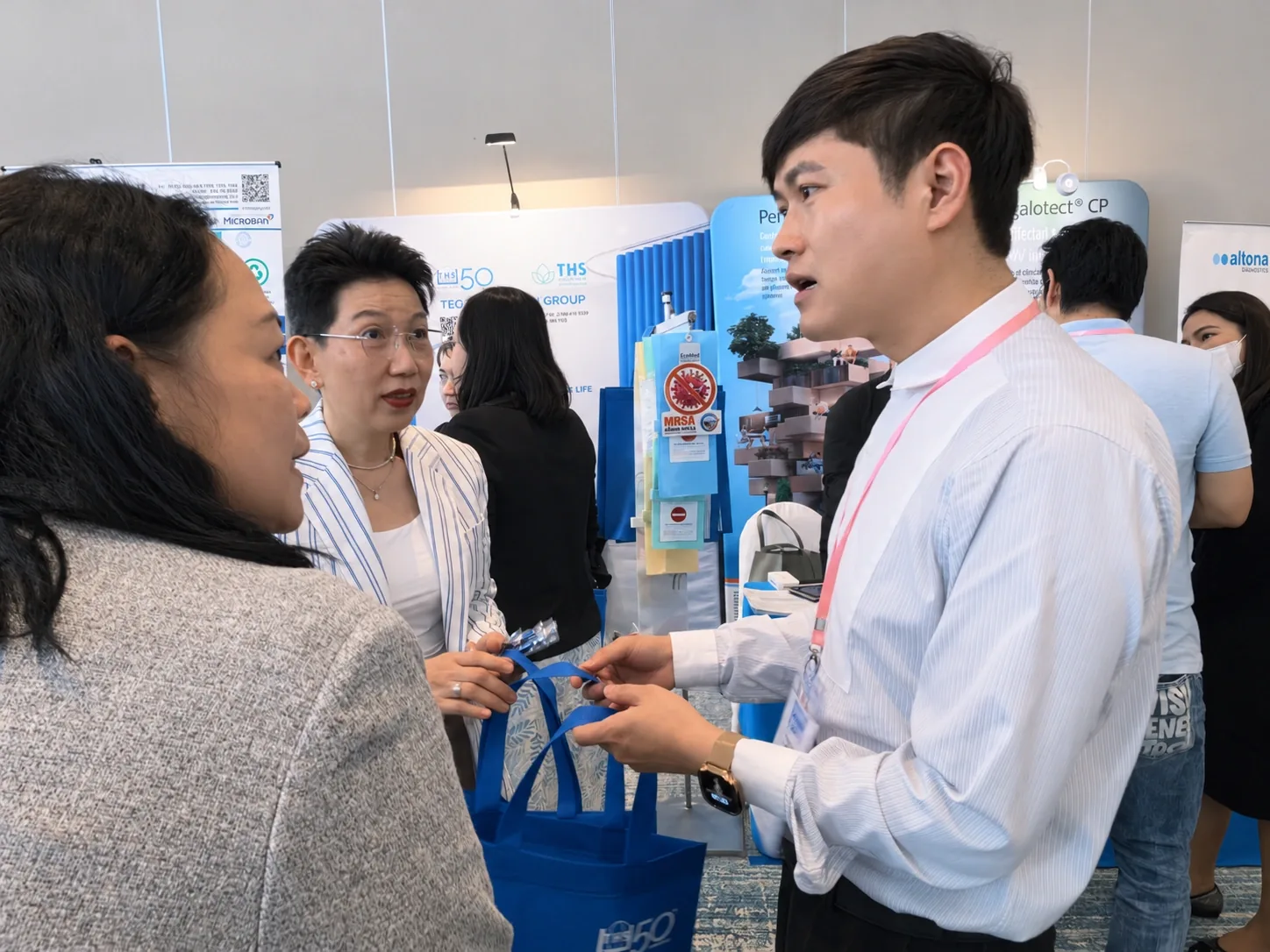 Team members exchanging information with attendees