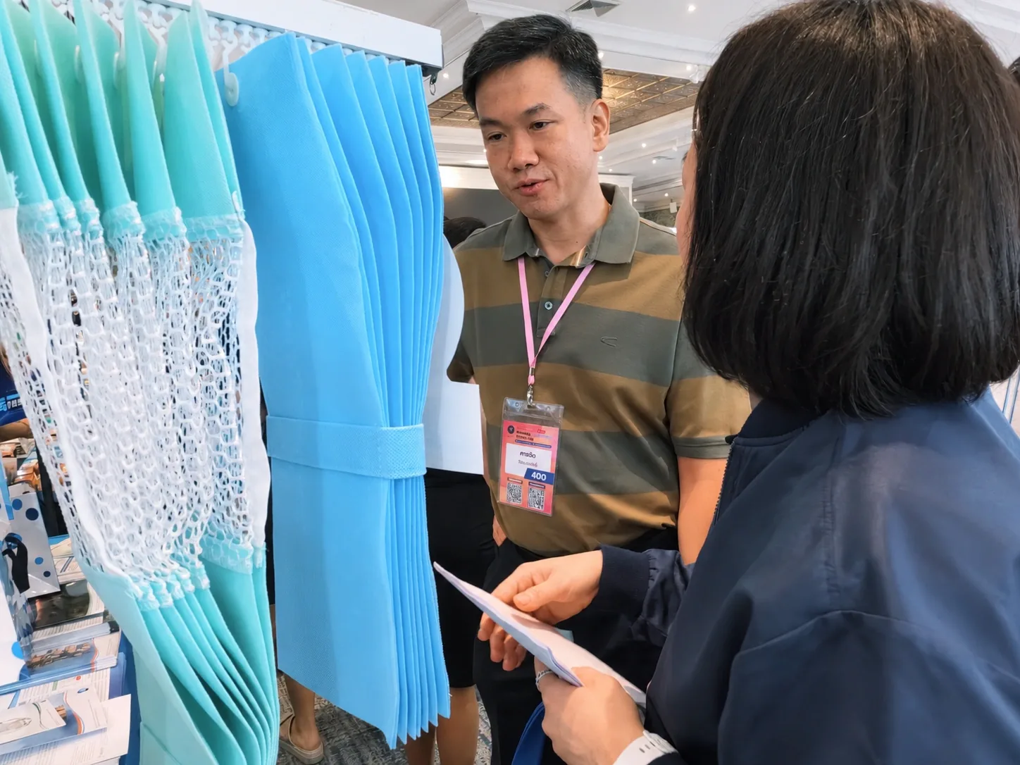 An attendee asking about EcoMed curtain samples