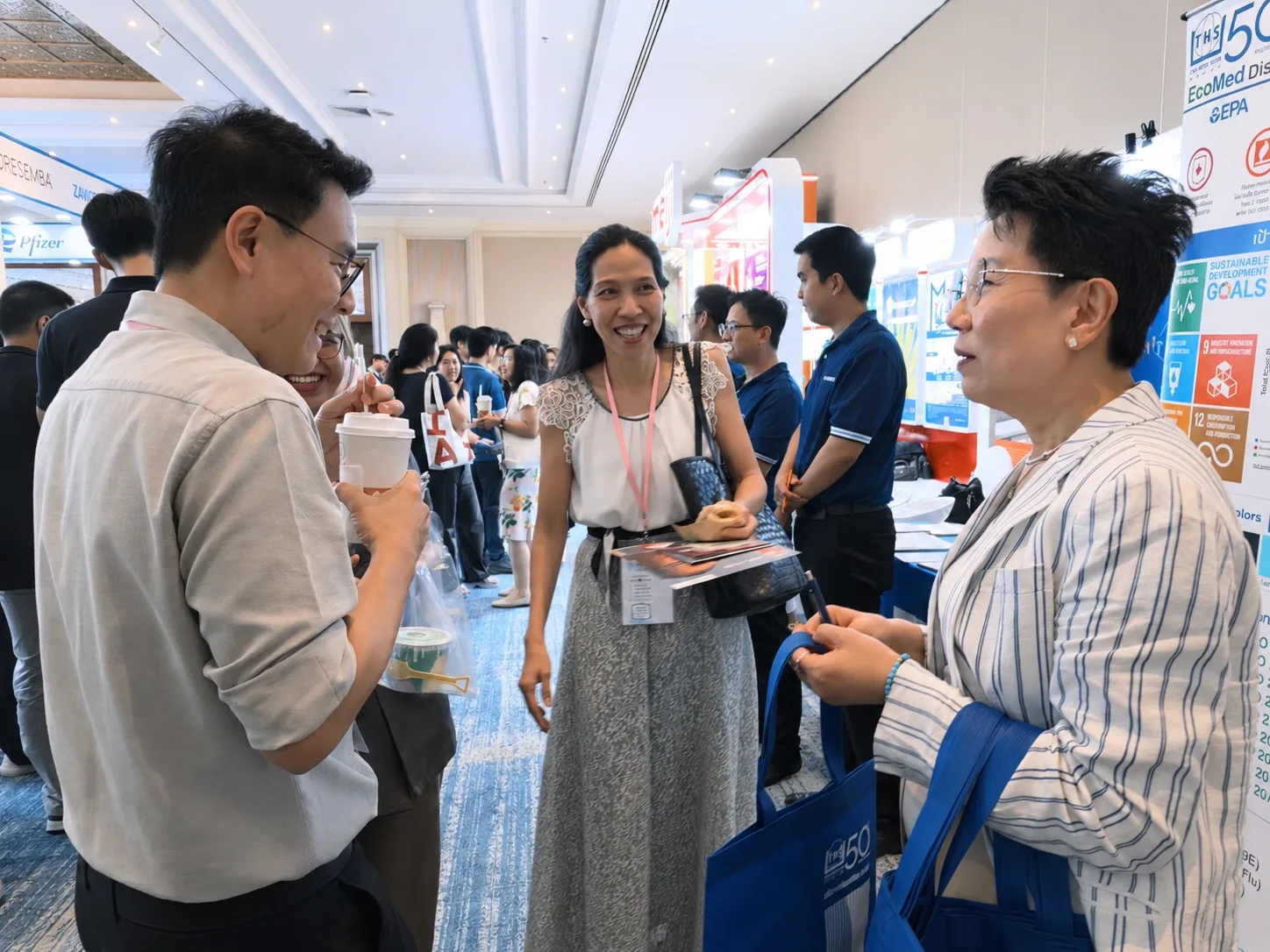 Attendees exchanging information in the exhibition hall