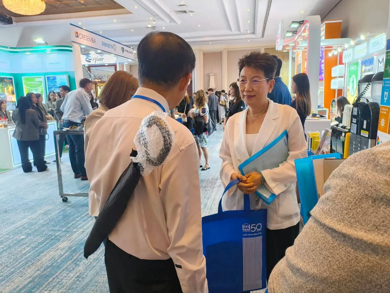 Team members welcoming attendees at the booth