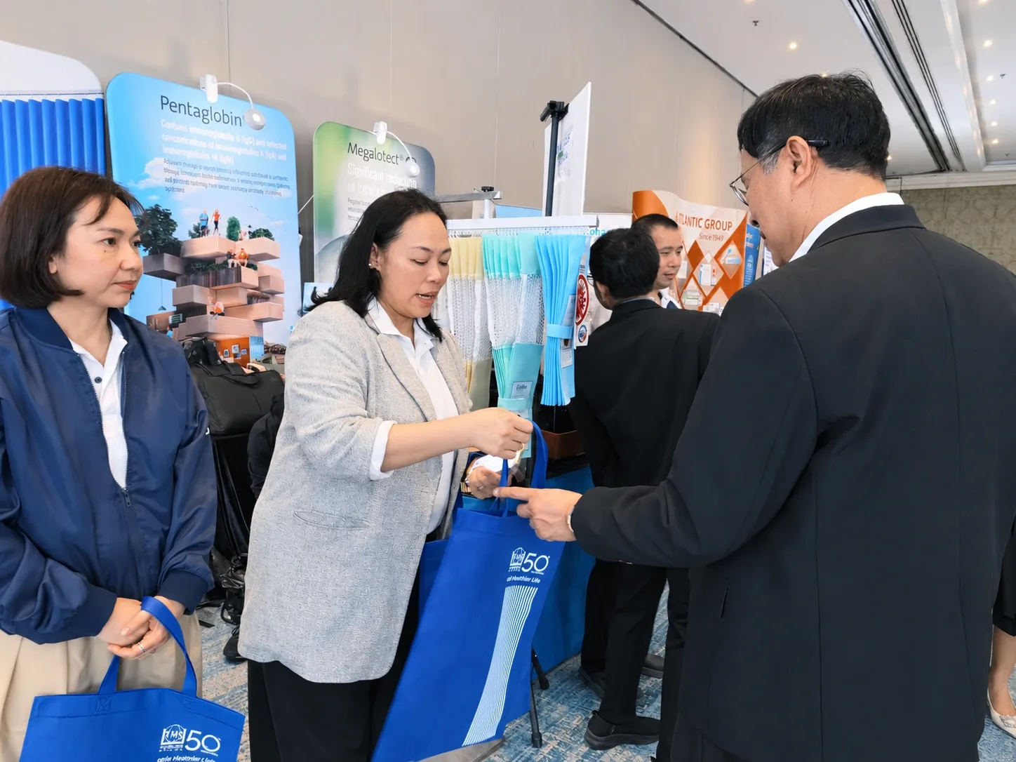 Team members giving souvenirs to attendees