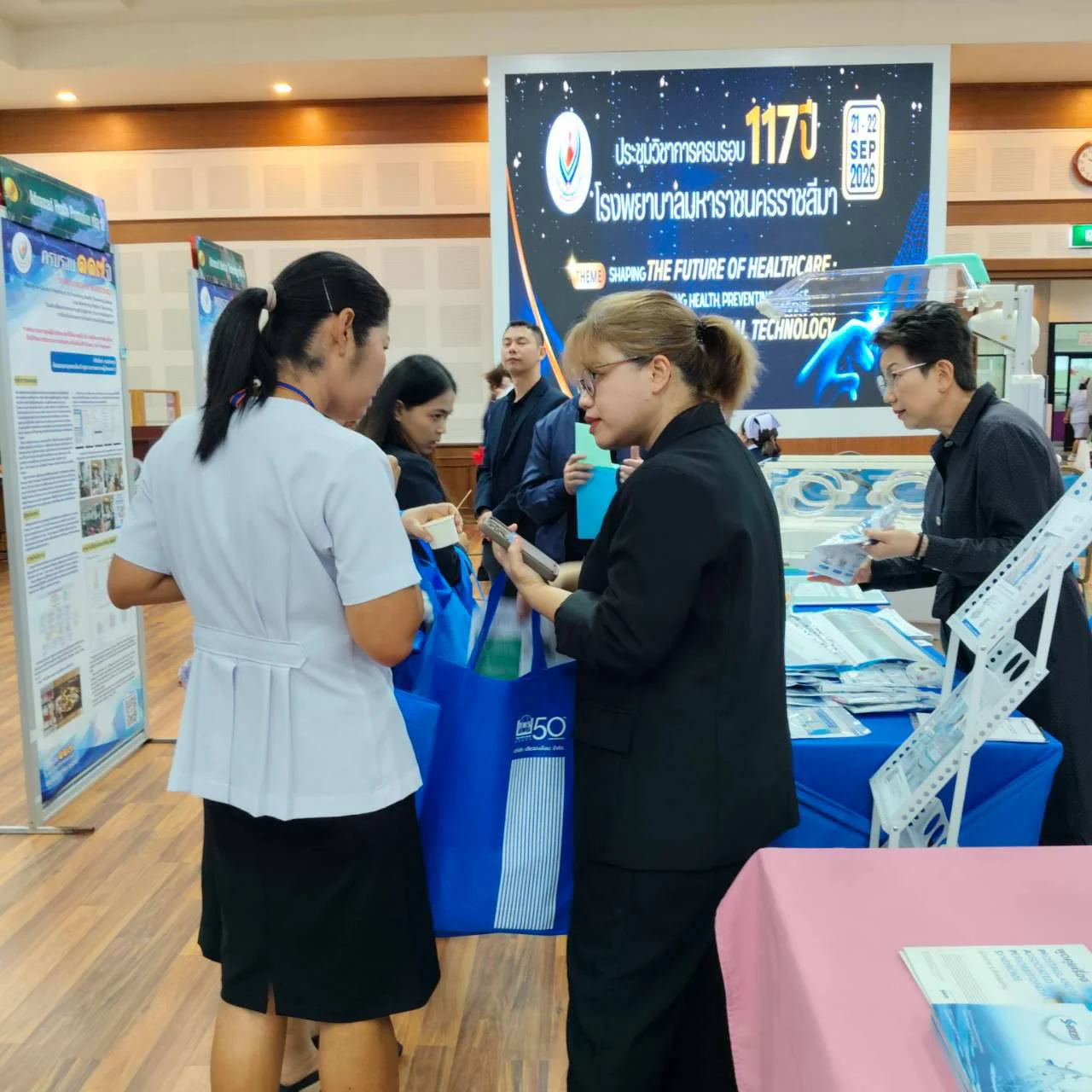 Conference attendees at the booth