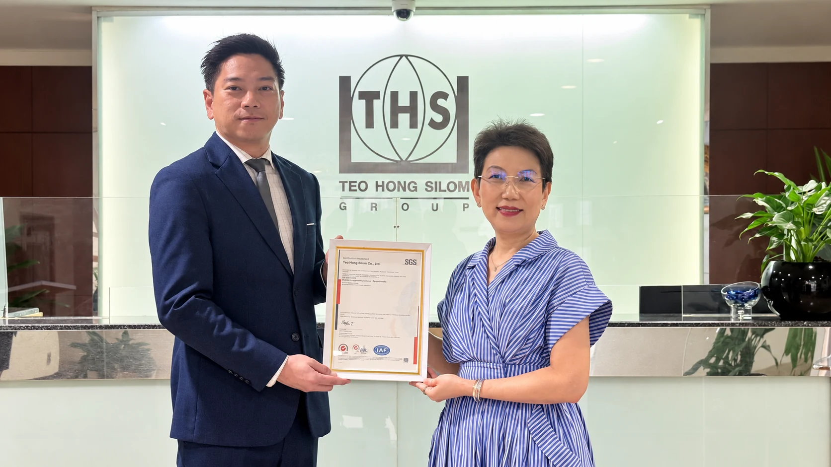 Ms. Kanyakorn Sirirat-Asdon receiving the ISO 9001 certificate from SGS