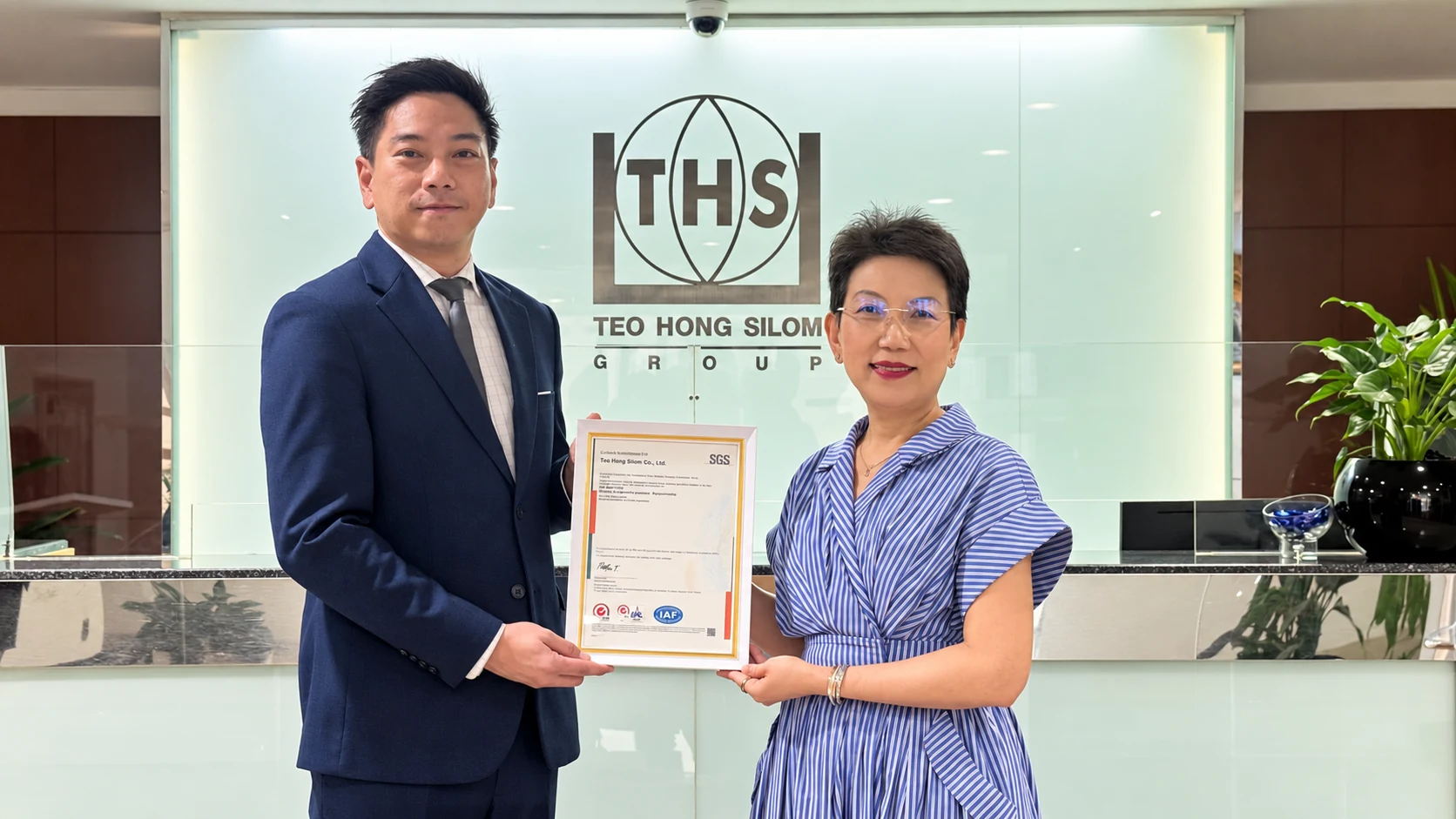 Teo Hong Silom executives posing with the ISO 9001 certificate from SGS