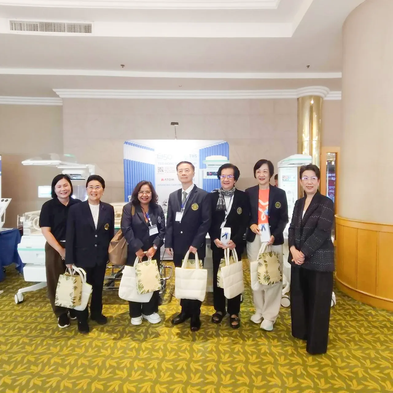 Attendees posing together at the booth