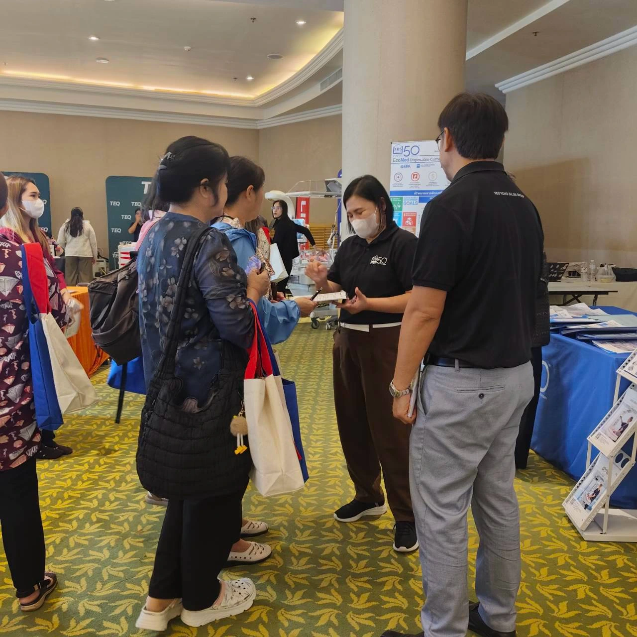 Team member explaining products to visitors