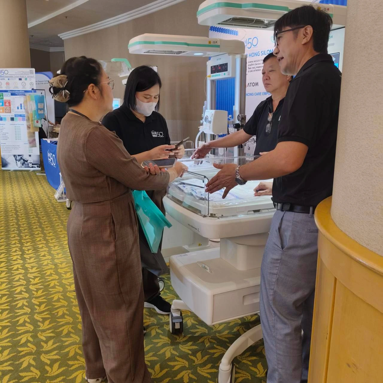 Team demonstrating equipment at the booth