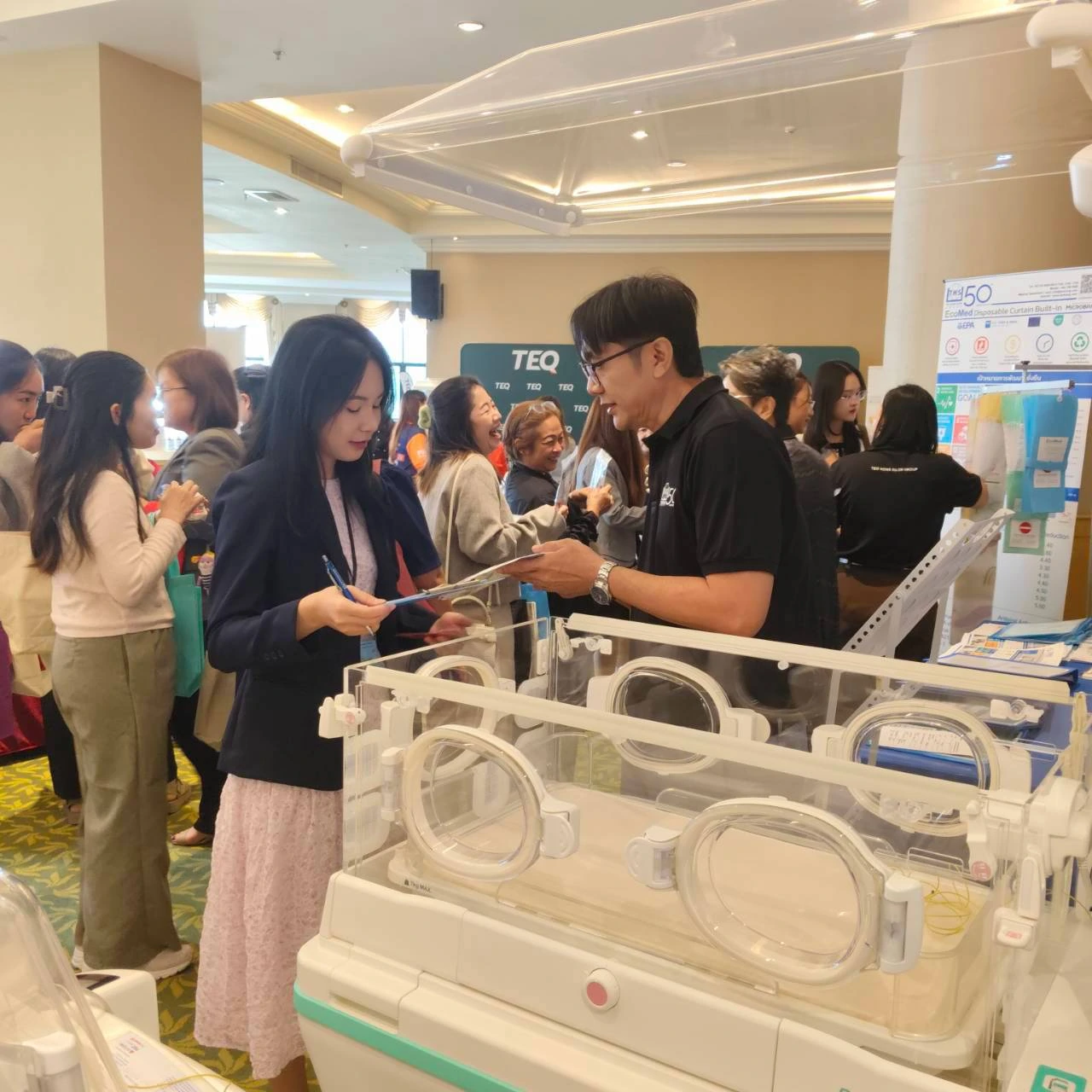 Visitors viewing a neonatal incubator